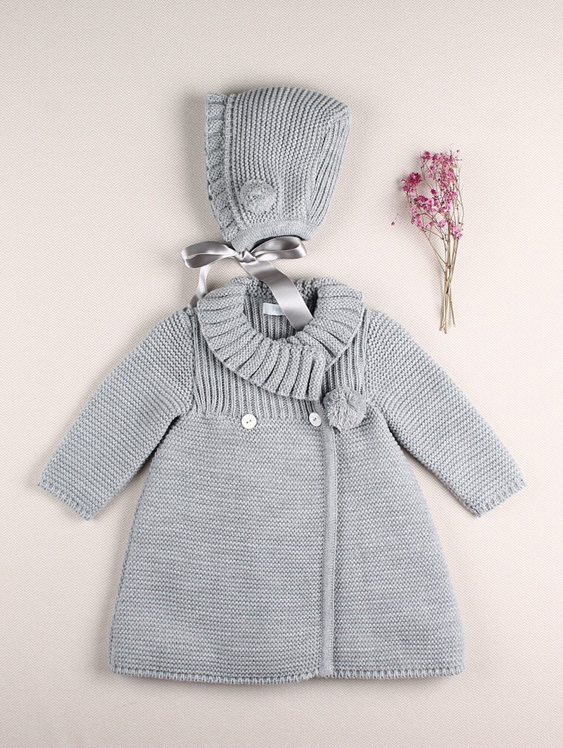 Knitted coat and bonnet with pompoms